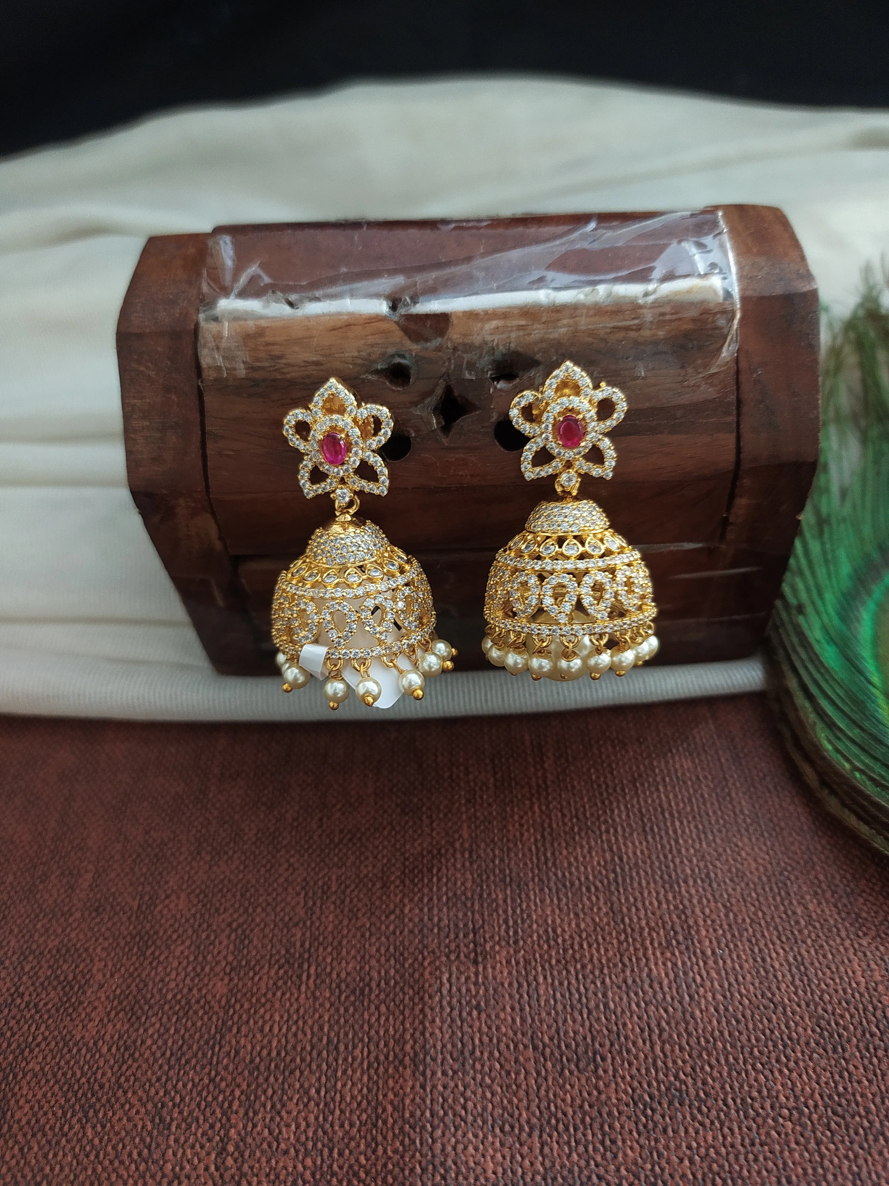 Alluring Gold Plated Jhumka With Zircon Stones With Pearl Dangling