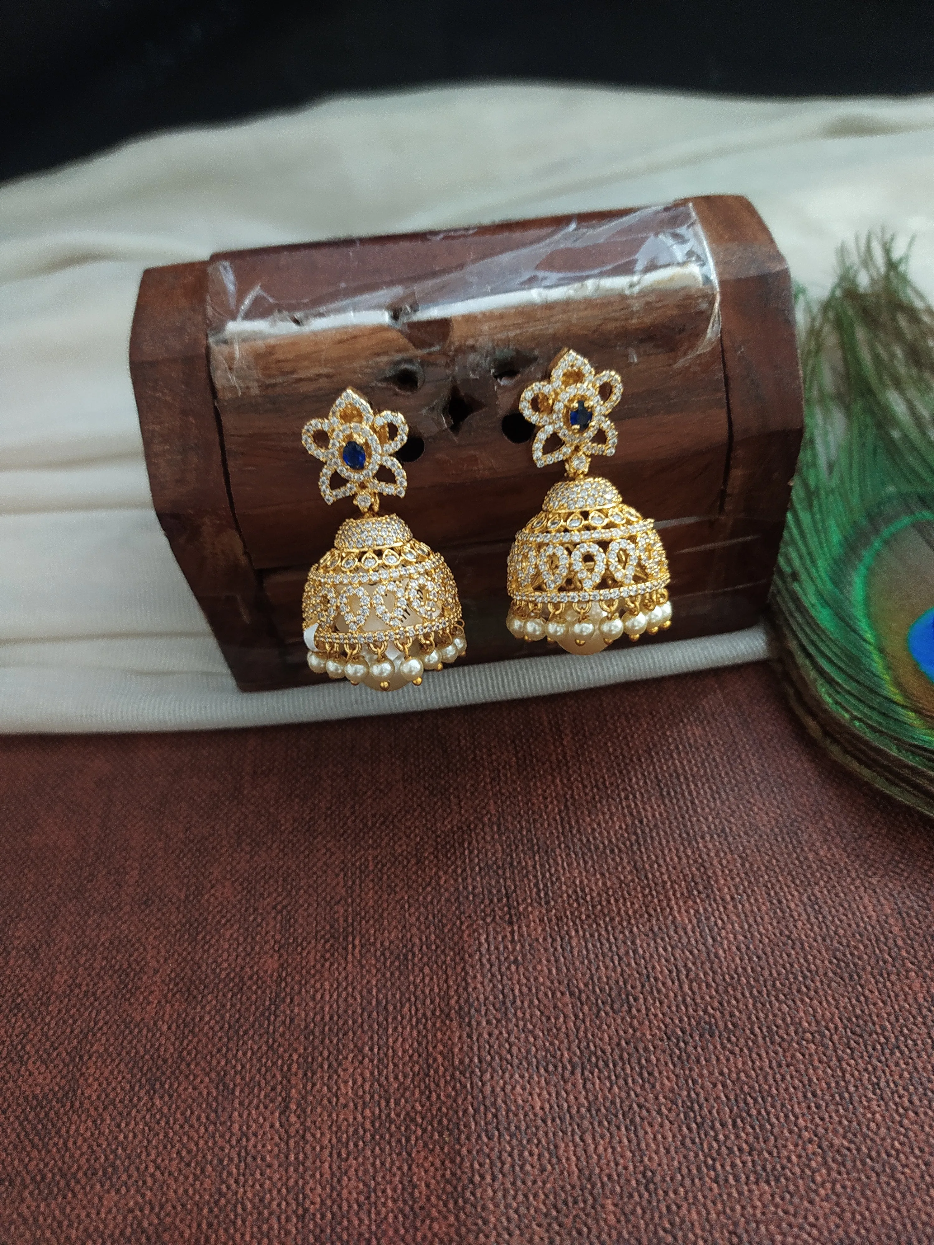 Alluring Gold Plated Jhumka With Zircon Stones With Pearl Dangling