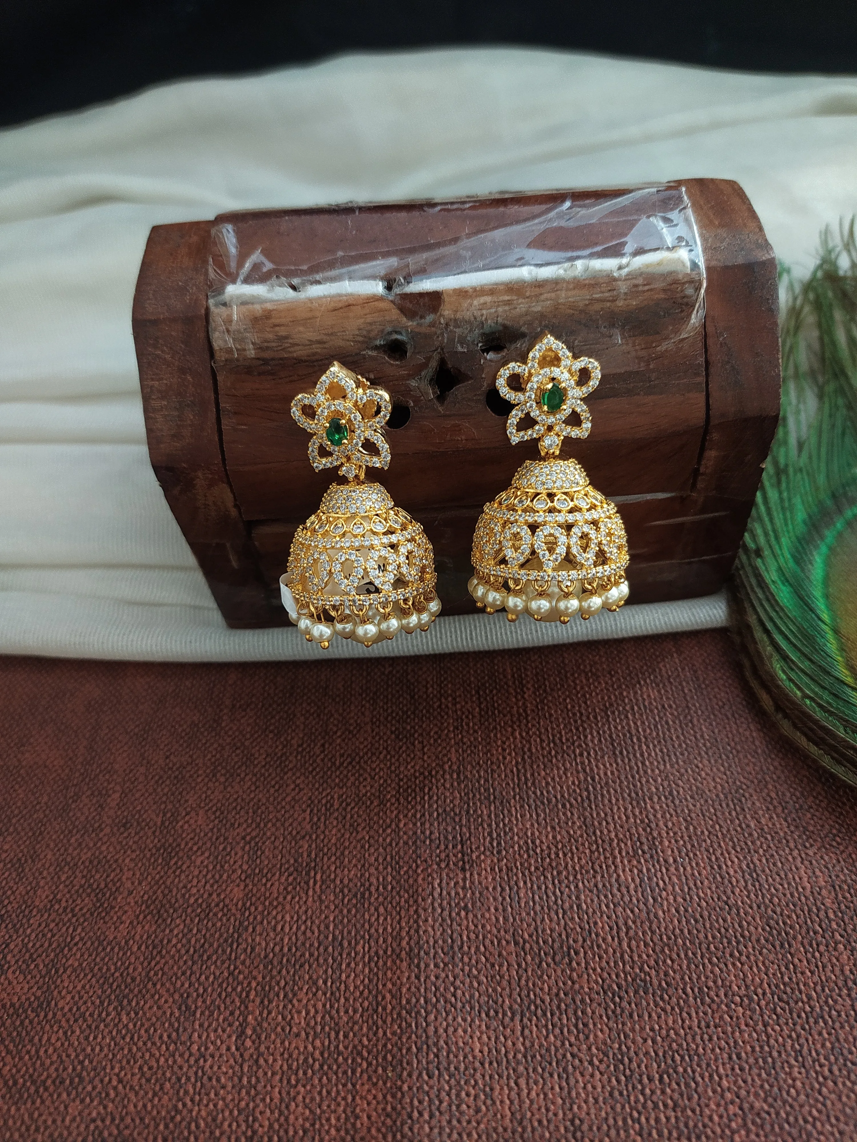 Alluring Gold Plated Jhumka With Zircon Stones With Pearl Dangling