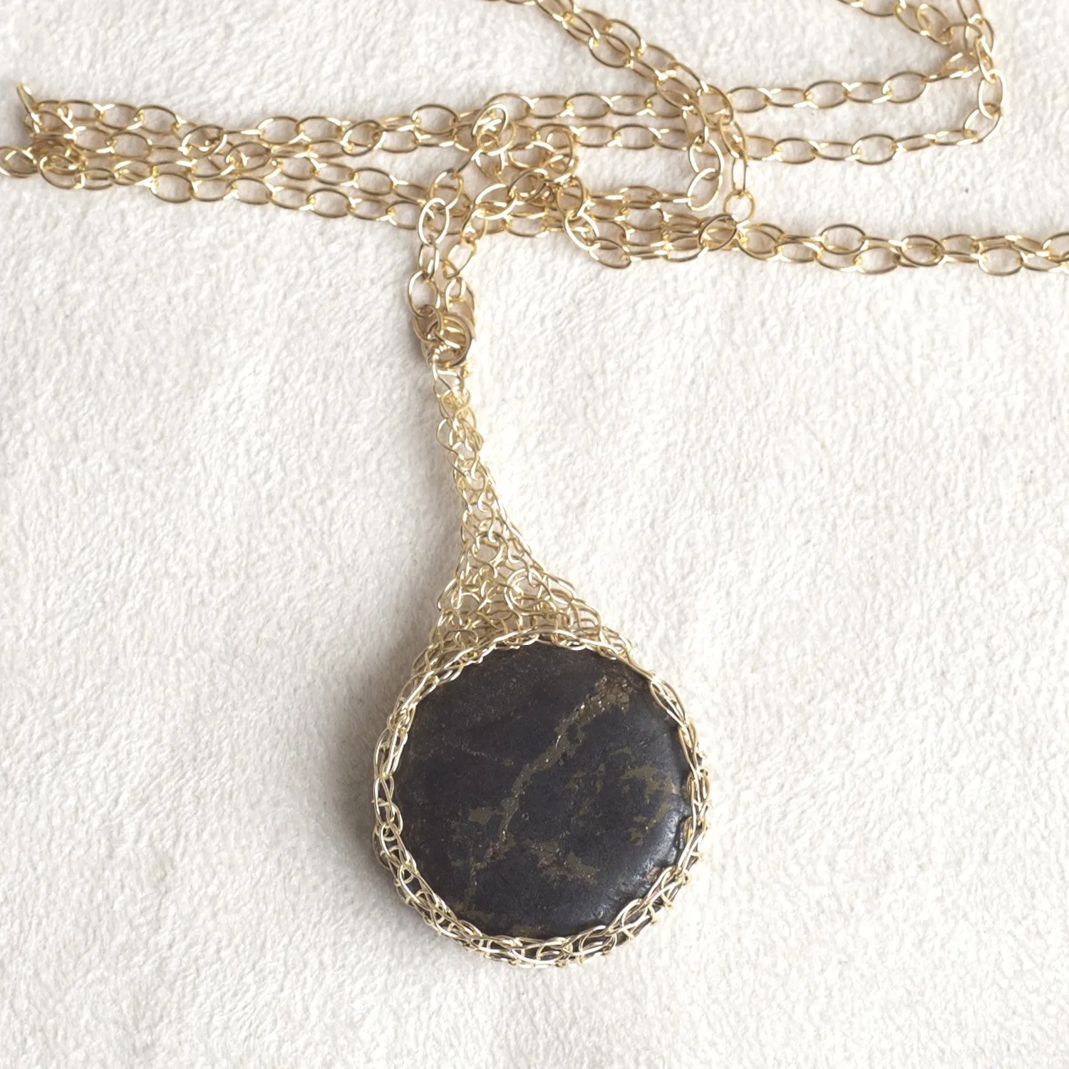 Large round Pyrite pendant necklace, nested in gold wire crochet