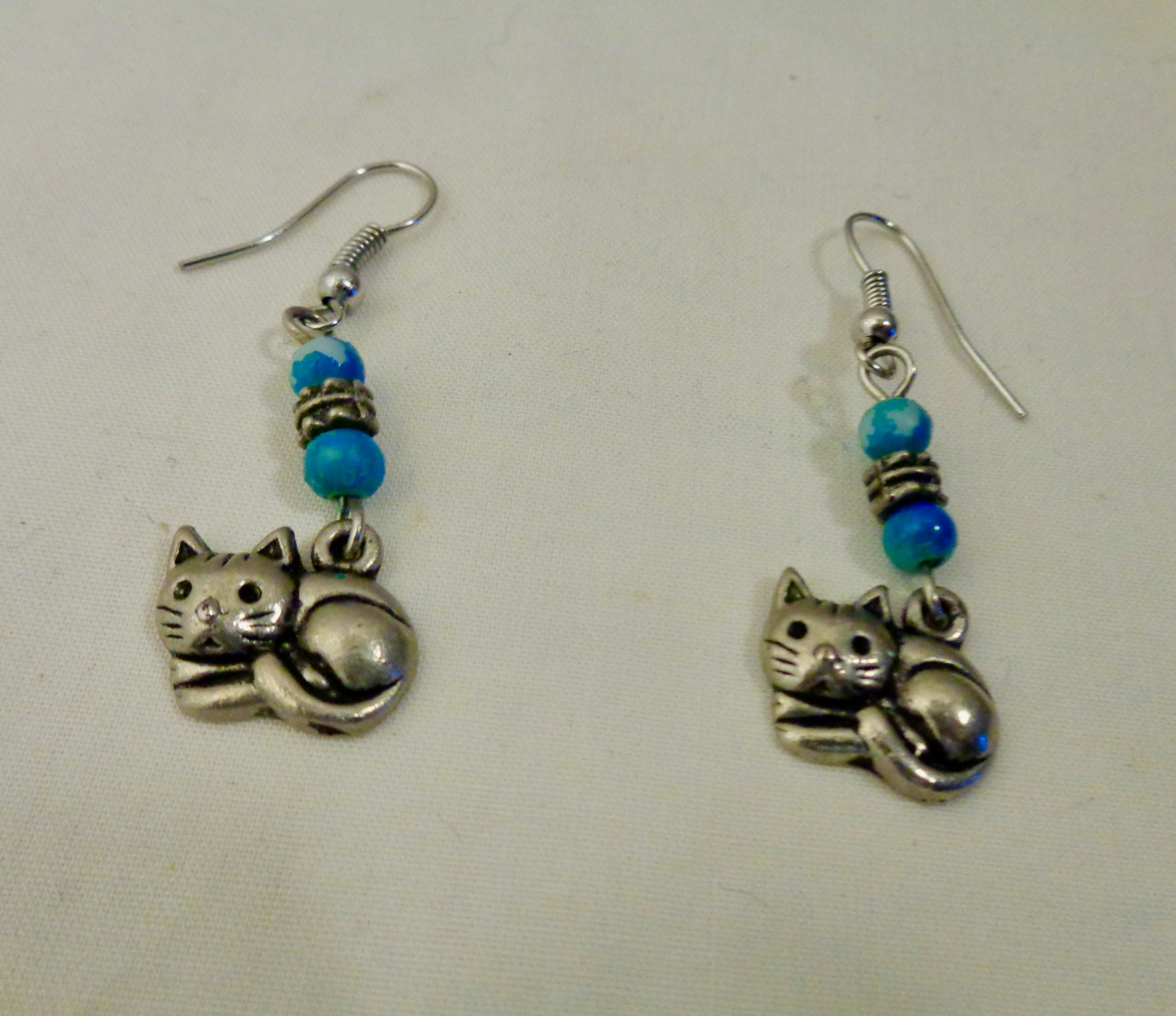 Silver Coloured Metal Cat Dangle And Drop Earrings With Blue Coloured Beads